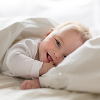 Baby Smiling in Bed
