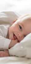 Baby Smiling in Bed