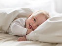 Baby Smiling in Bed