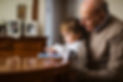 Grandfather with his grandson looking a digital tablet