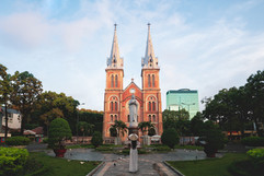 Vietnamese girl wearing ao dai standing in front of the Notre-Dame Cathedral Basilica of S