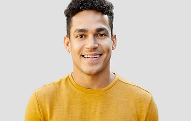 smiling man in yellow editing reviews