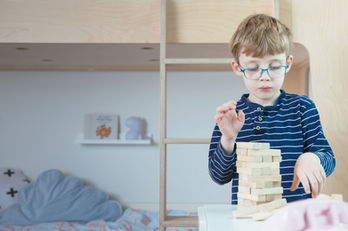 child playing with blocks during therapy