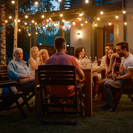 family enjoying dinner in an outdoor living space