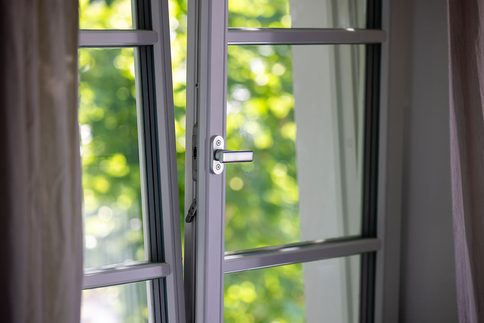 Close-up of a window with white frames and curtains