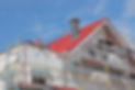 A House with a red roof under construction with scaffolding