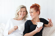 Women Laughing on Couch