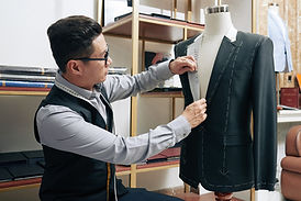Asian male tailor working on a jacket