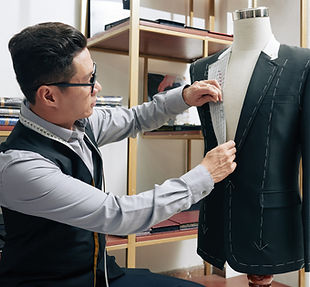 Asian male tailor working on a jacket