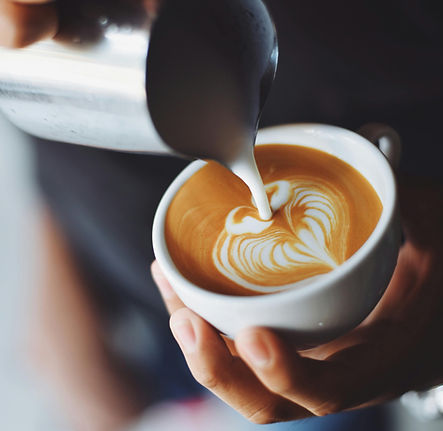 Barista pouring latte