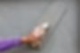Smoothing wet plaster on the wall with a wooden-handled trowel