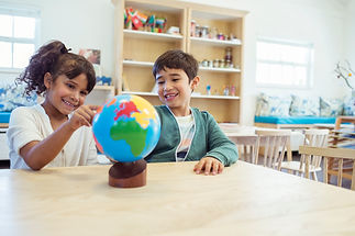 Children exploring a globe
