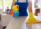 A person cleaning kitchen counter