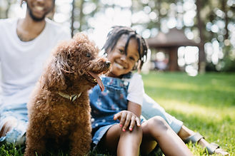 Dog with Family in Background