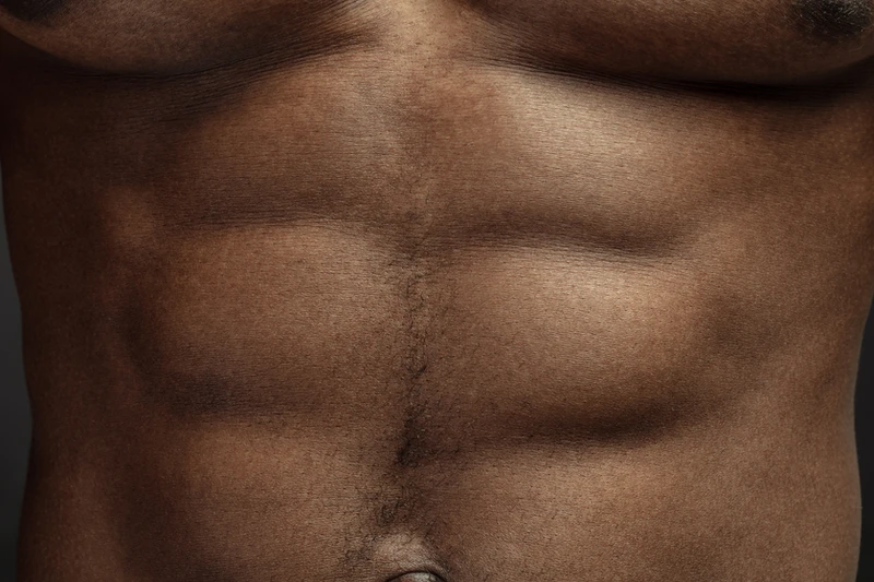 Close-up of well-defined abdominal muscles, showing core strength effectively.