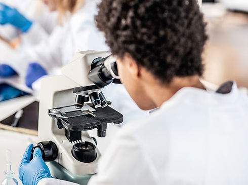 Scientist using microscope