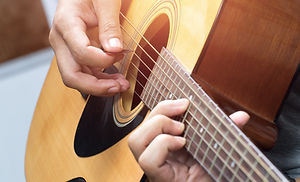 Man playing guitar at home
