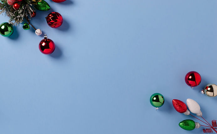 a light blue background with red and green Christmas ornaments set onto it