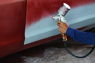 Professional spray painting a car