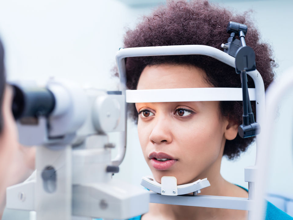 Eye doctor performing retina examination