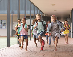 Kids running out of a school.