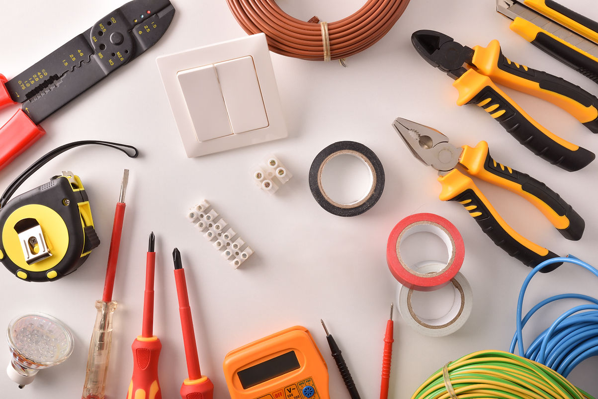 Tools and electrical material on a white table general view Horizontal composition. Top vi