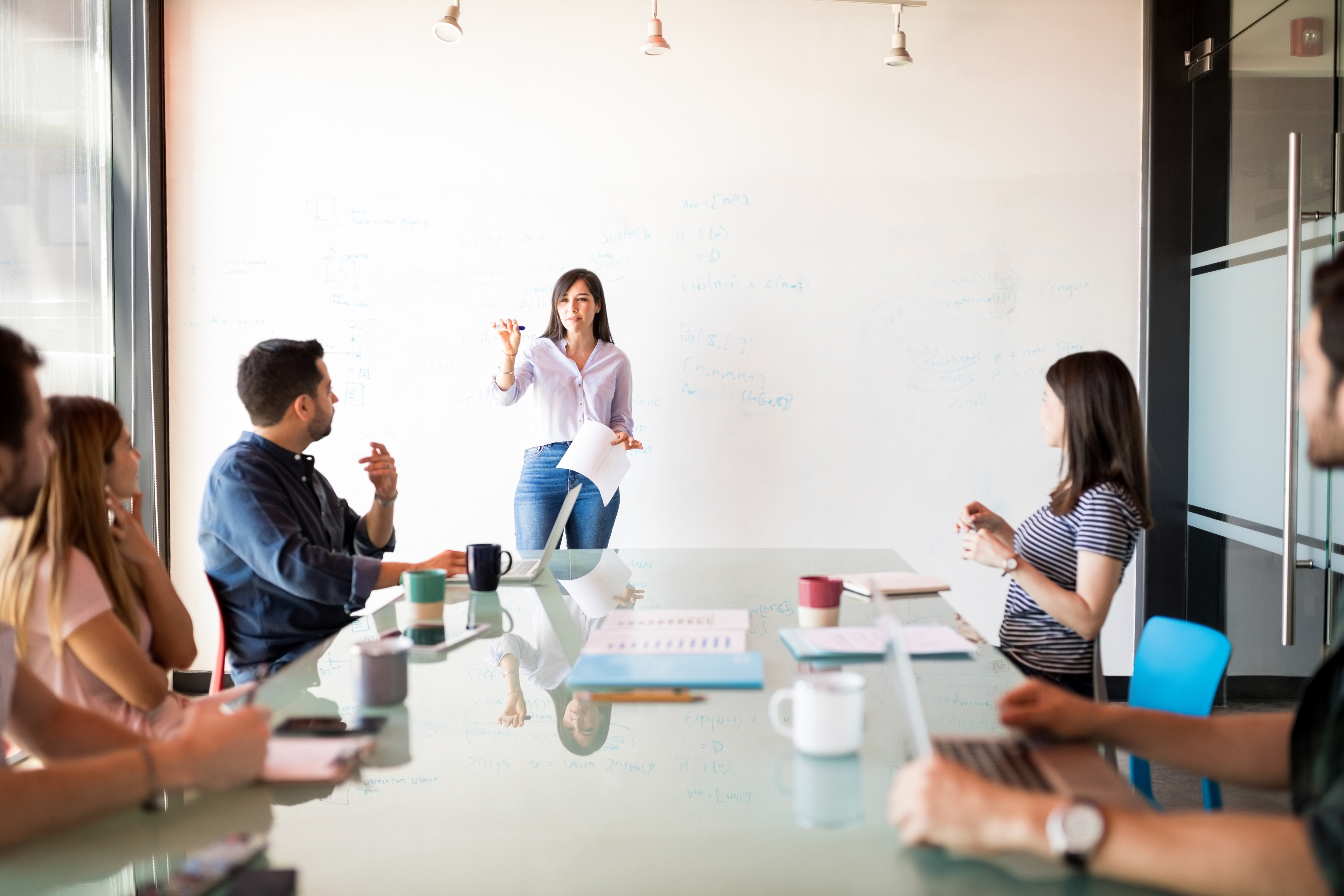 A group of people discussing web development outsourcing options