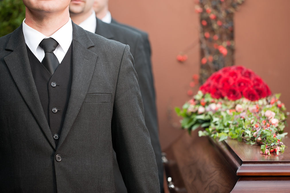 Coffin bearer carrying casket at a funeral