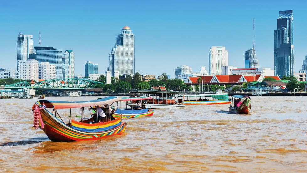 A ferry and long tail boats in the Chao Phraya river
