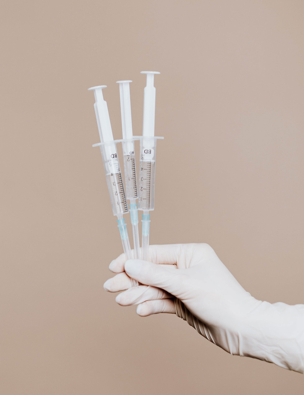 Hands holding syringes