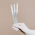 Hand Holding Syringes
