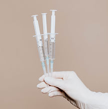 Hand Holding Syringes