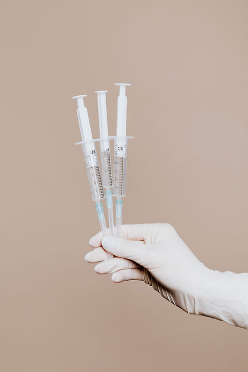 Hand Holding Syringes