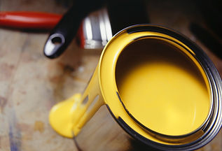 Can of yellow paint and brushes