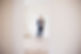 Woman standing in a bright empty room with wooden flooring