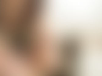 Mum and baby breastfeeding calmly on the bed.