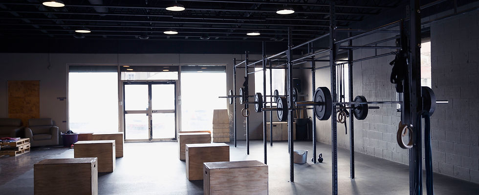 Empty CrossFit gym with sun shining through windows