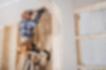 Construction Worker working on walls and ceiling