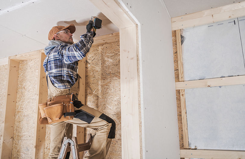 Worker Installing Drywall