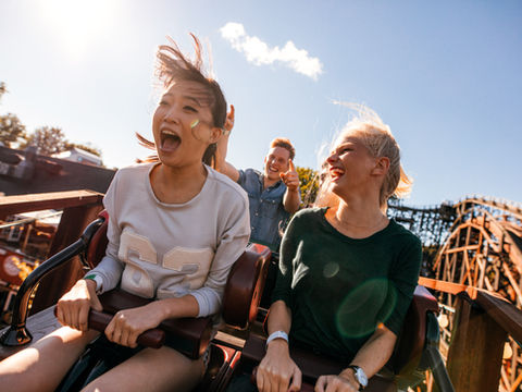 Two women riding a rollercoaster