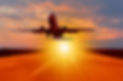 Passenger plane fly down over take-off at sunset