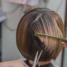 Hair cut with a scissor over comb method