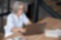 Elderly woman working on laptop