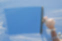 A cleaner washing a window with a squeegee