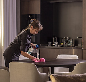 Housekeeper Wiping the Table