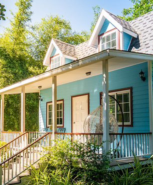 A blue house surrounded by nature