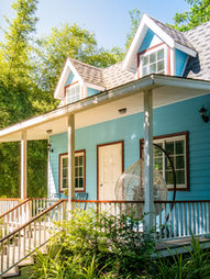 A blue house surrounded by nature