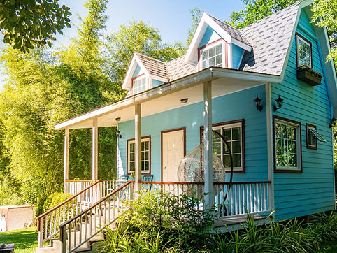 A blue house surrounded by nature