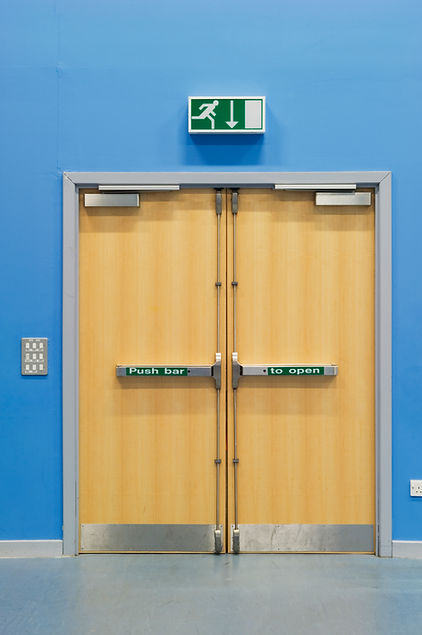 Light wood double fire doors with silver push bars