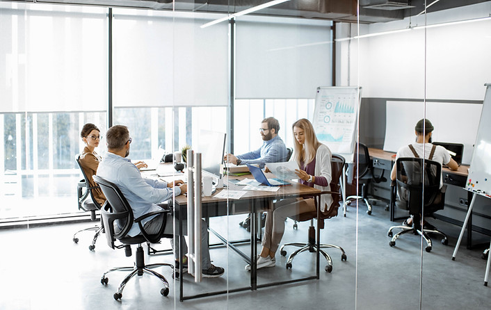 Team Working in Glass Partitioned Office
